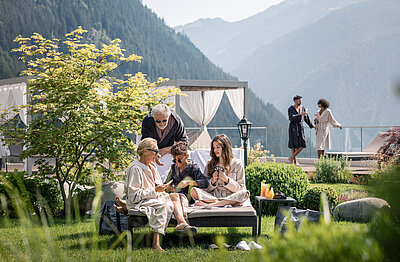 Family playing cards on the lawn in Family Hotel STOCK resort in Austria