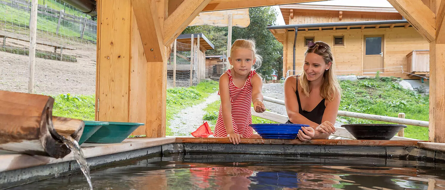Mother and child panning for gold in the exhibition gold mine