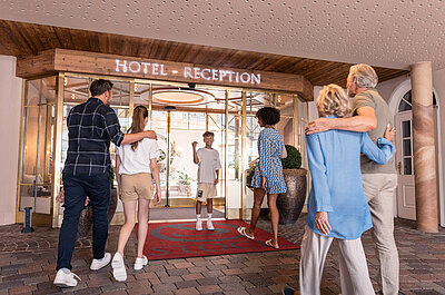 Family at the entrance of Family Hotel STOCK resort Austria