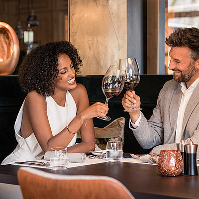 Couple enjoying wine in Gourmet Hotel STOCK resort